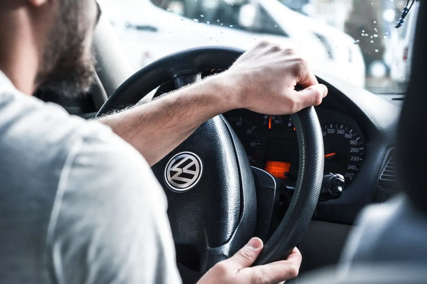 Hands gripping a steering wheel, focused on the road ahead