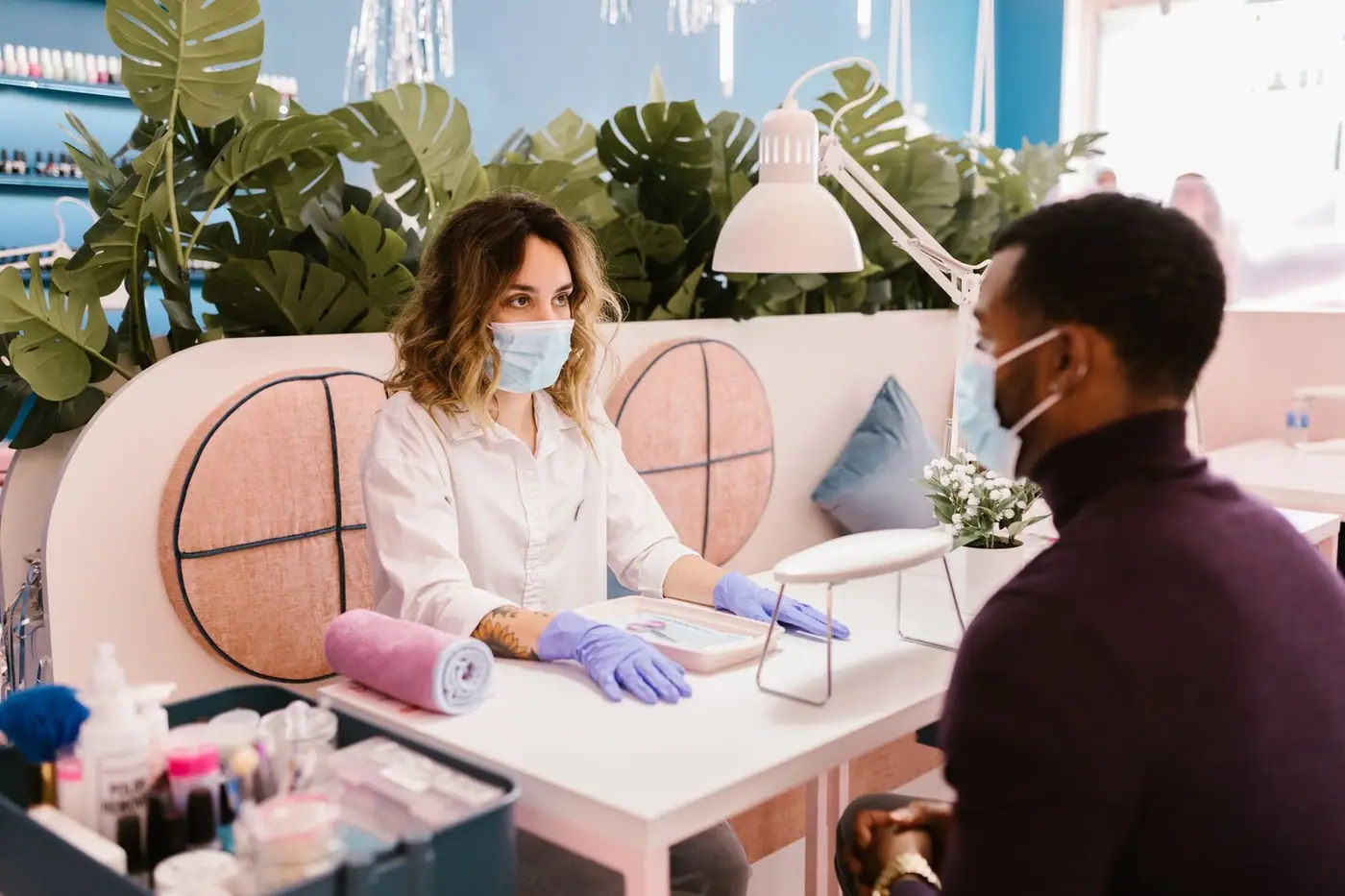 A man receiving a manicure in a stylish nail salon.