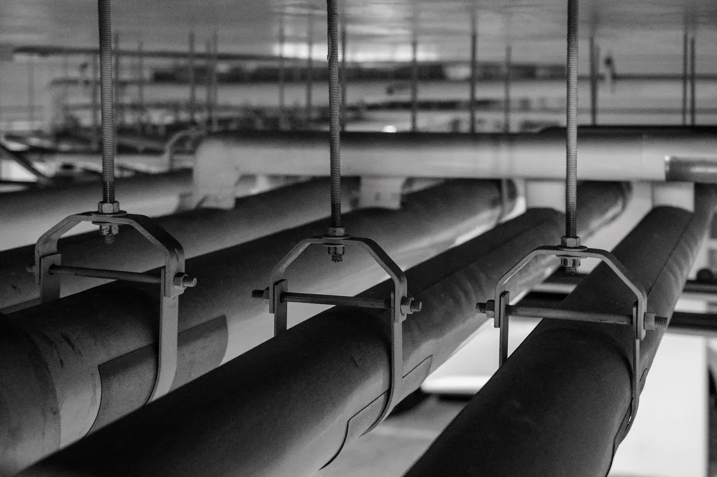 Black and white photo of industrial pipes and fittings.