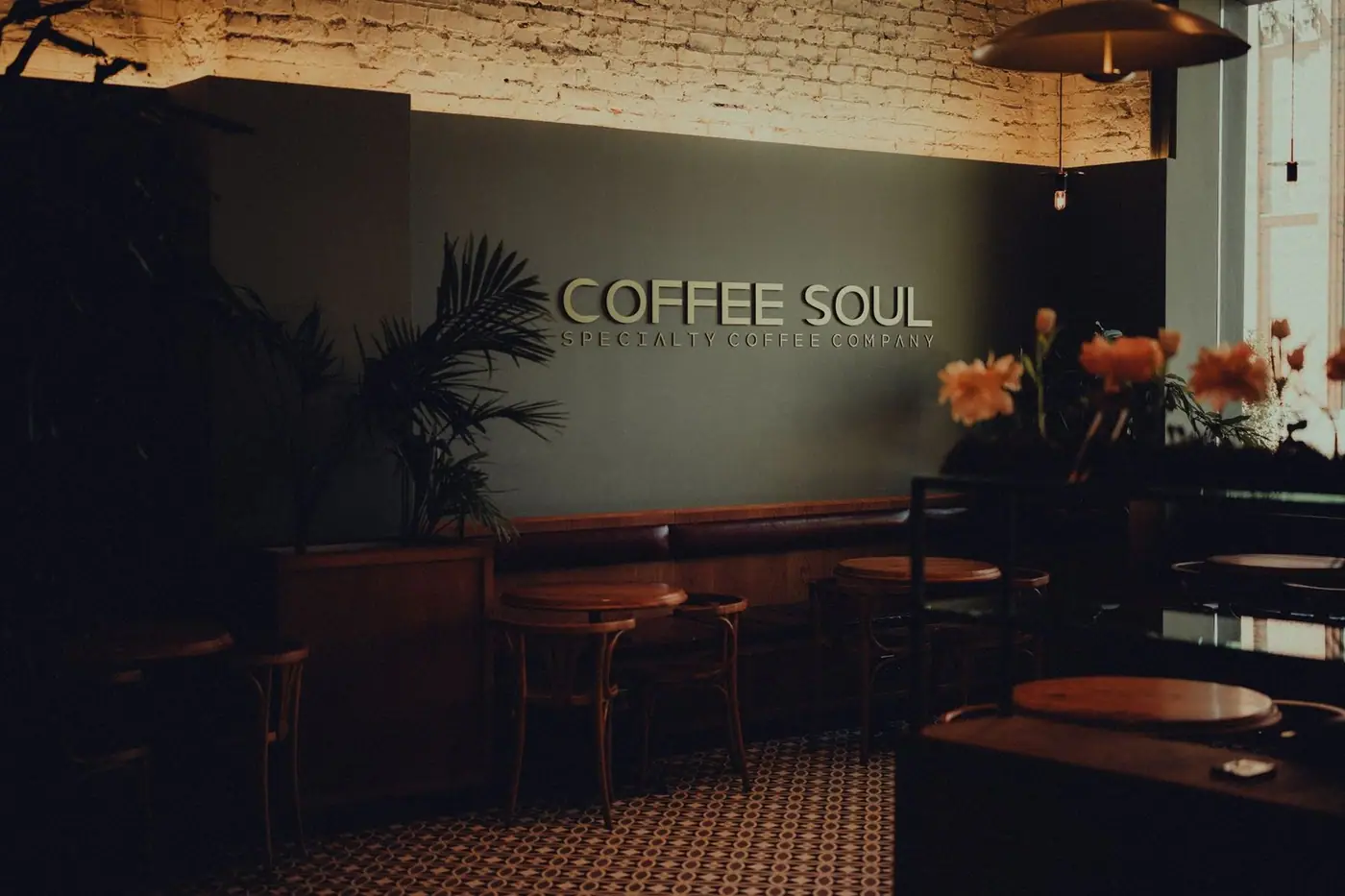 A warm, inviting cafe interior with rustic wooden furniture and plants