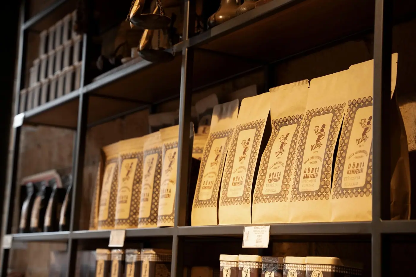 Artisan coffee bags neatly arranged on rustic shelves in a cosy shop setting