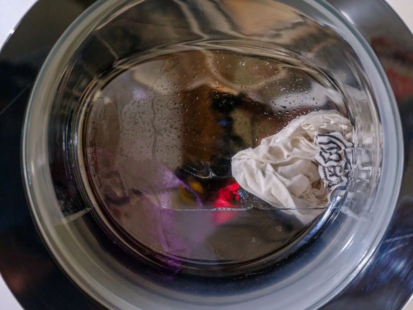 Wet clothes spinning inside a front-loading washing machine