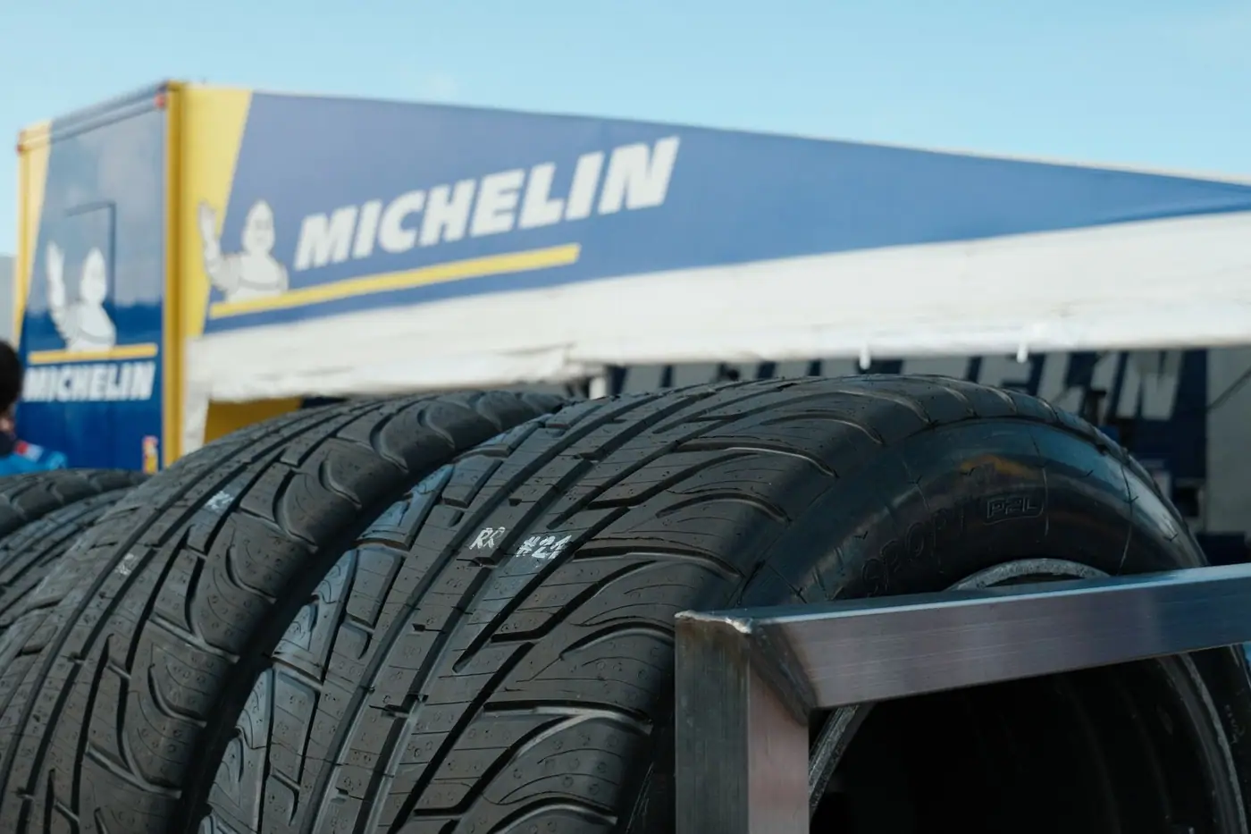 Stacked car tyres on display with prominent branding