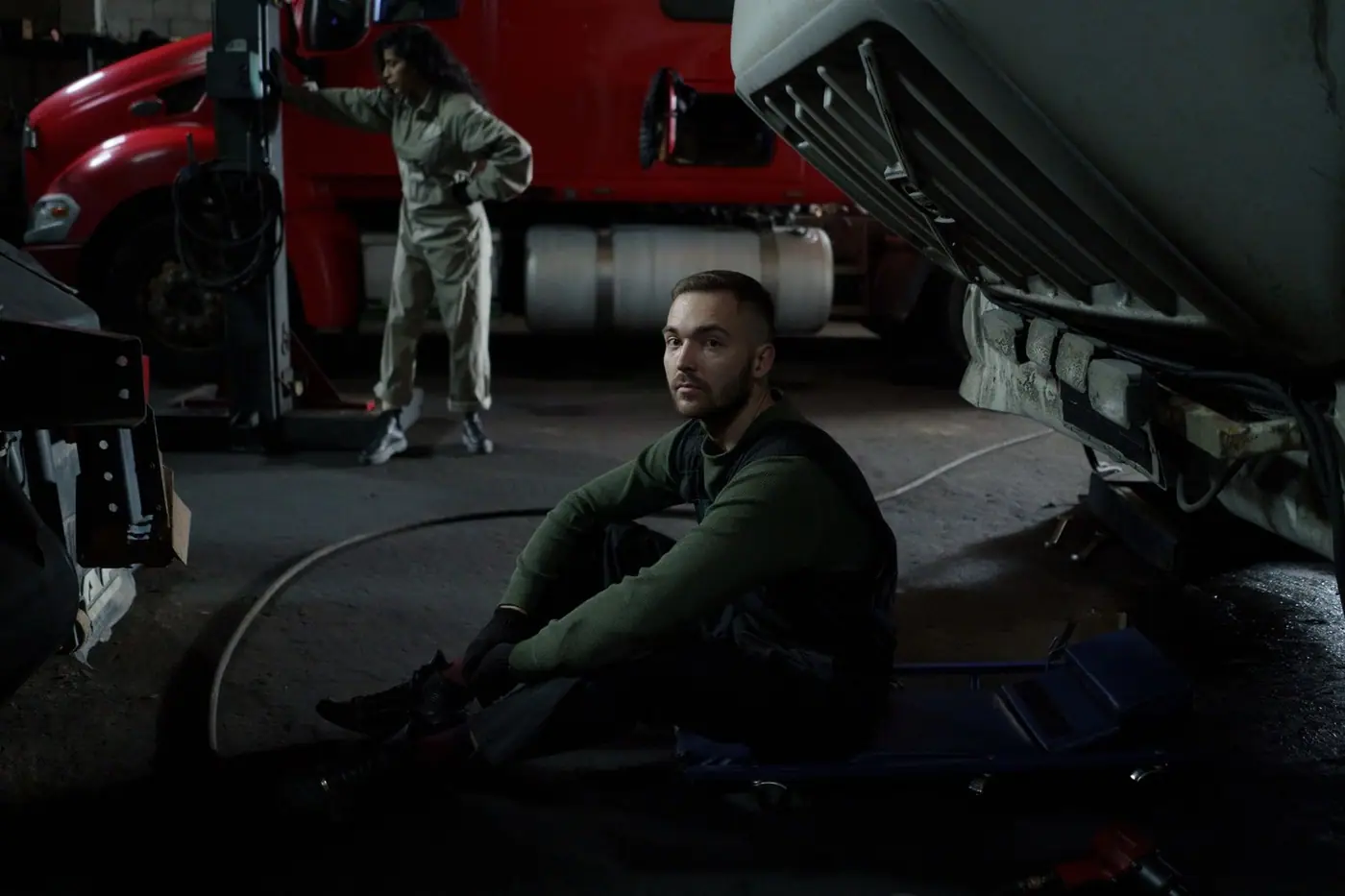 Mechanics working on a truck in a workshop