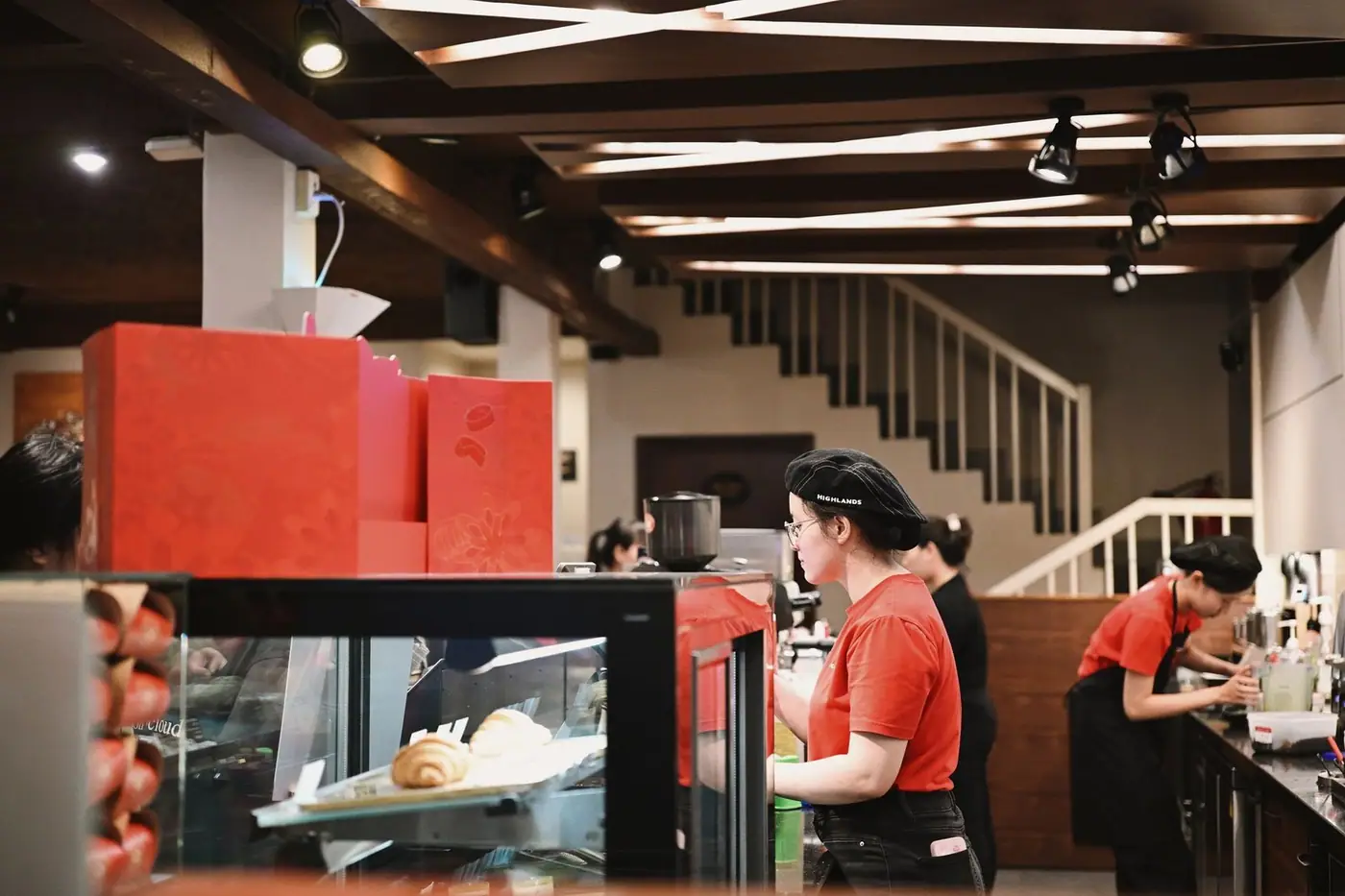 Baristas preparing drinks in a busy cafe