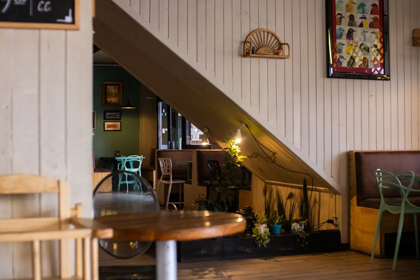 Inviting café interior with wooden decor, empty seats and ambient lighting