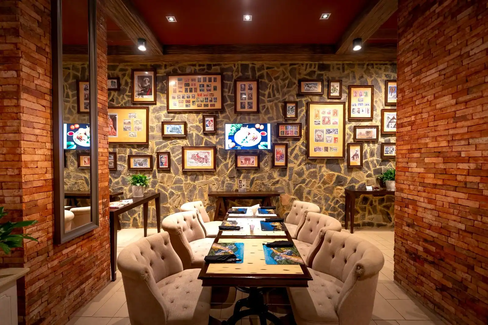 Chic restaurant interior featuring artistic wall decor and cozy seating arrangement.
