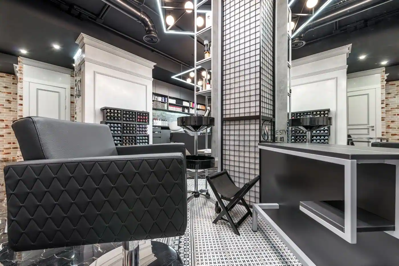 Contemporary and sophisticated barber shop interior with stylish furniture and lighting