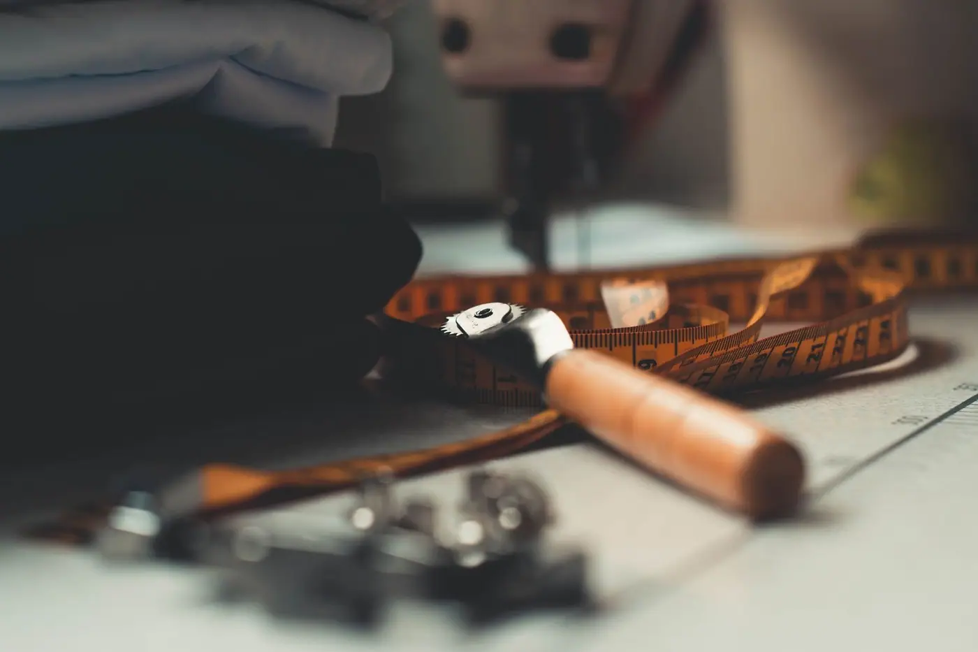 Tailoring tools and fabrics laid out on a workbench