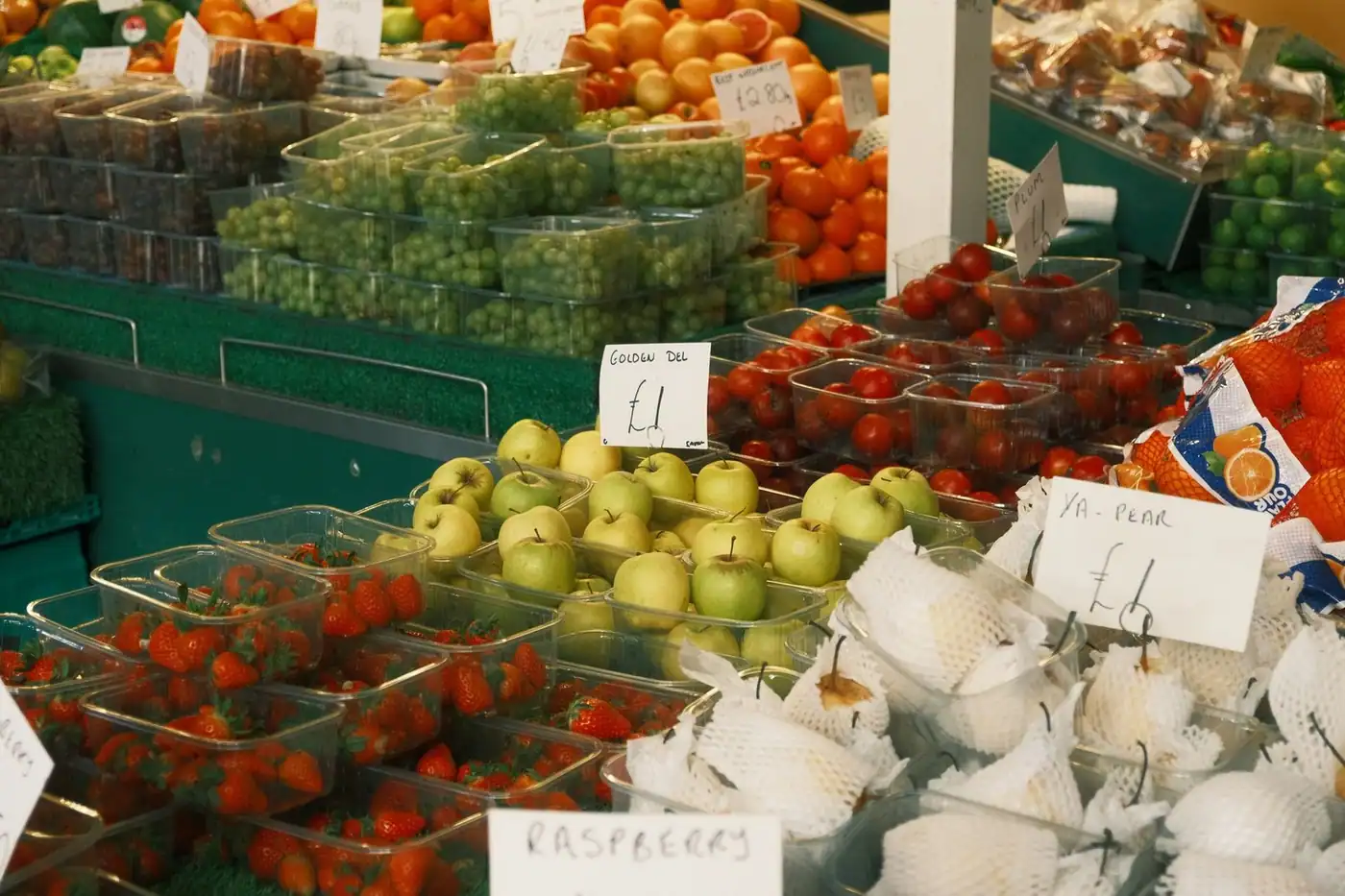 A colourful assortment of fresh fruit piled high on a busy market stall