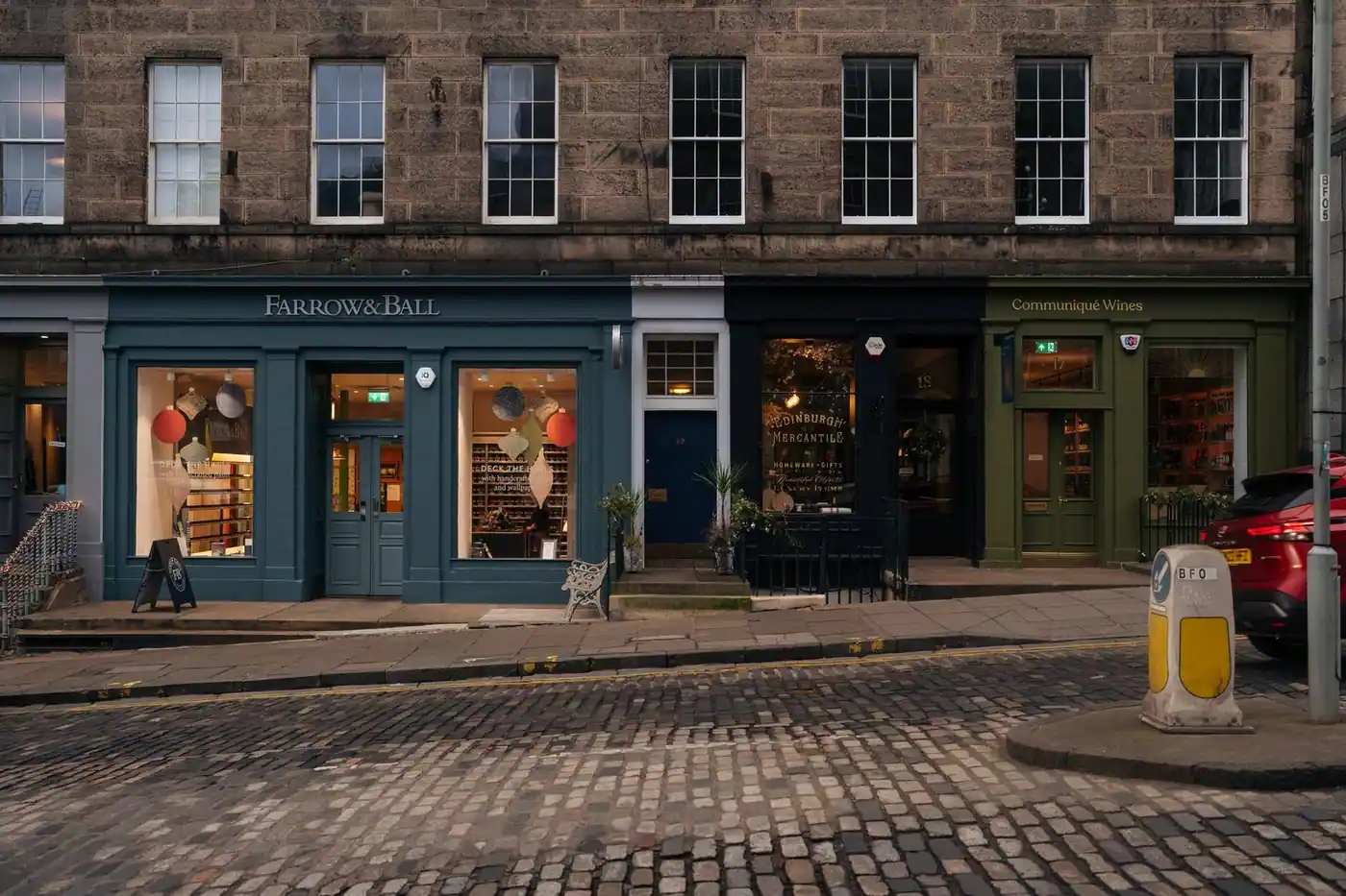 Charming shopfronts at dusk, painted in deep heritage colours
