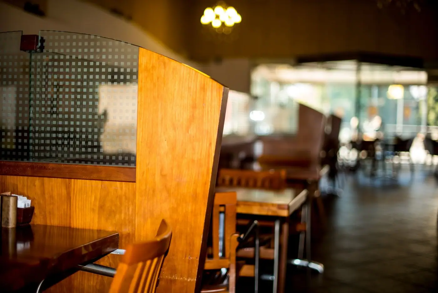A warm, inviting restaurant interior with wooden tables and chairs