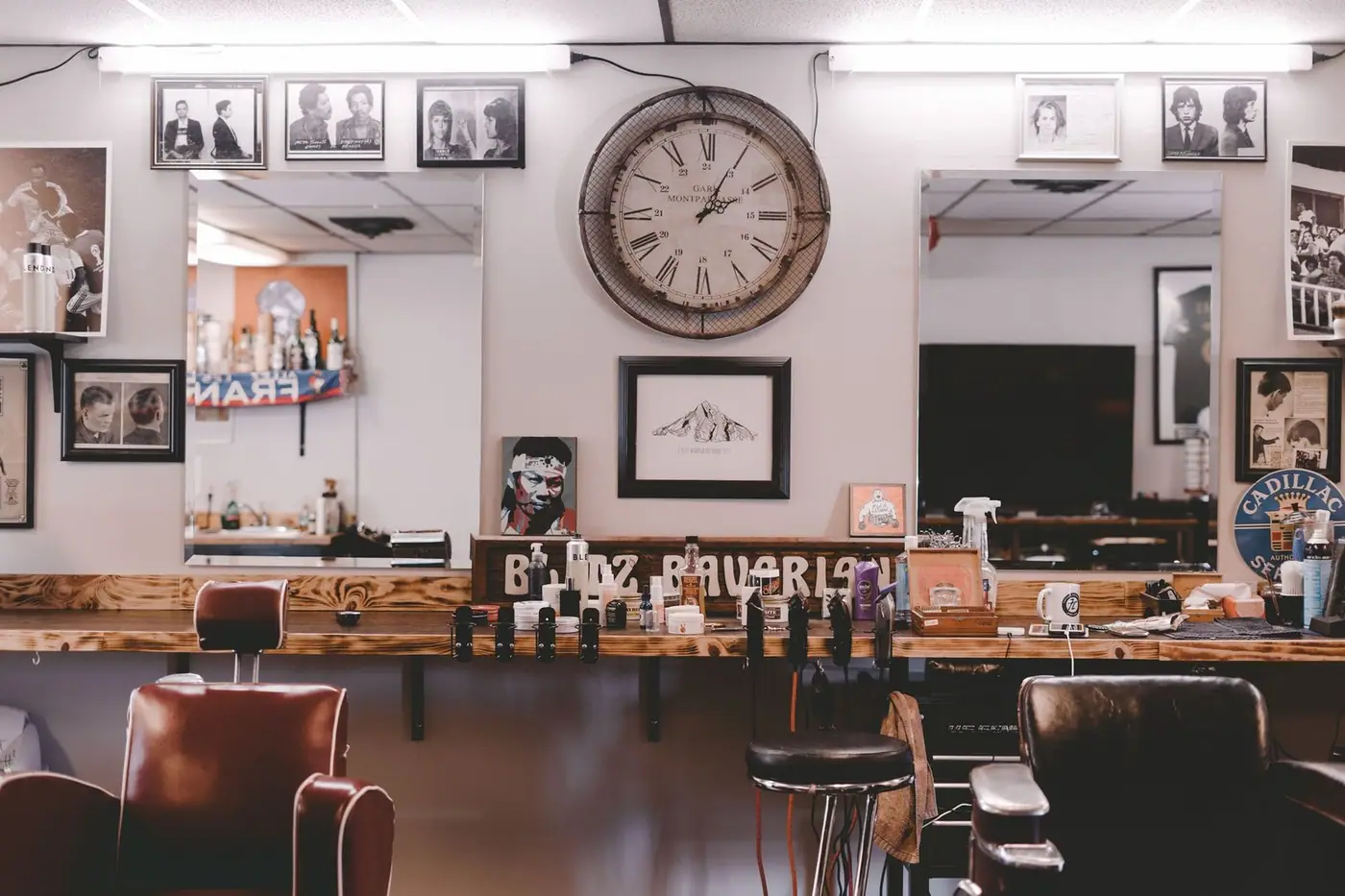 Cosy barbershop interior with leather chairs, souvenirs and framed photos on the walls