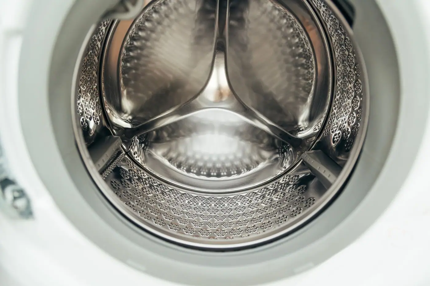 Close view of a clean stainless steel washing machine drum