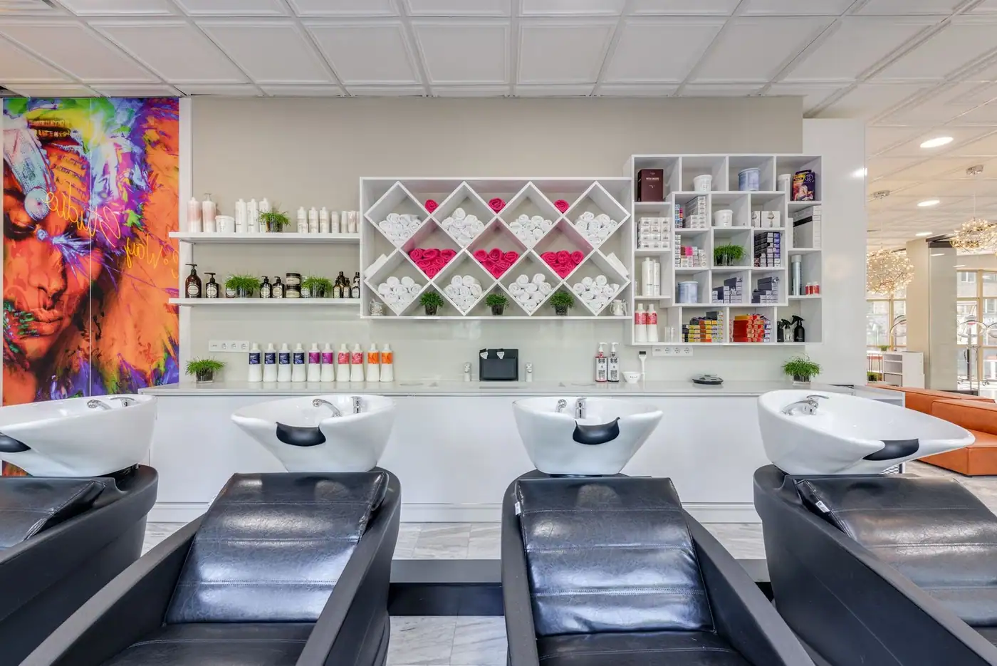 Beauty salon with stylish shampoo beds and colourful decor