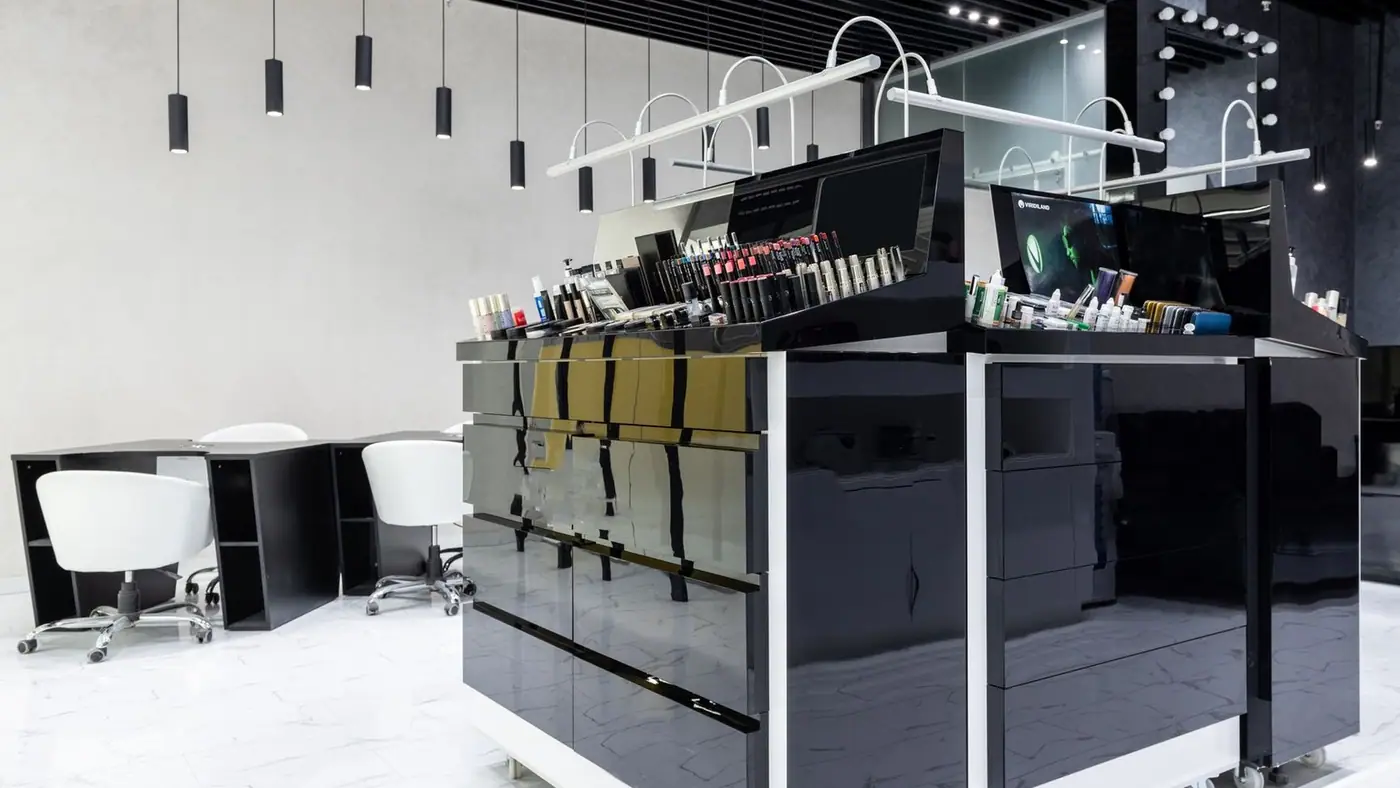Sleek and luxurious salon interior featuring modern cosmetics display and elegant lighting.